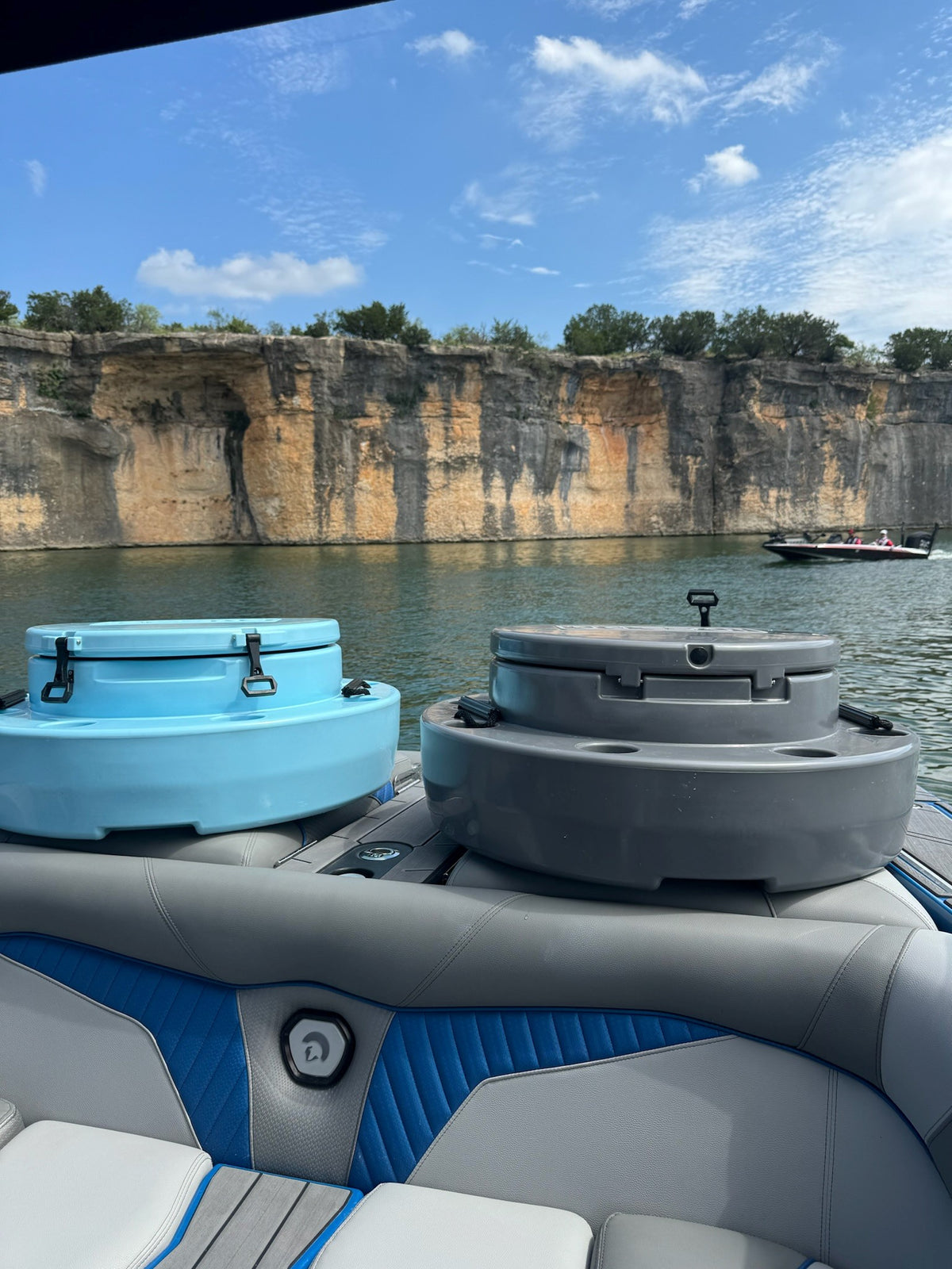 charcoal and blue ICEBRG coolers riding on boat